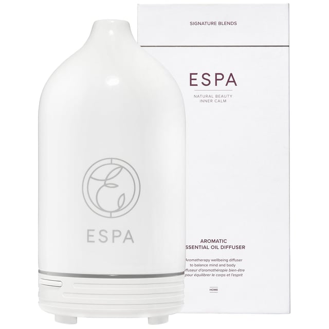 ESPA Aromatherapy Essential Oil Diffuser for Relaxation and Wellness Transform your living space with the ESPA Aromatherapy Essential Oil Diffuser. This stylish diffuser releases a mist of essential oils, enhancing your environment with soothing aromas that promote relaxation and well-being. It works seamlessly with ESPA's Signature Blends, helping you unwind or boost your mood. The ultrasonic technology humidifies the air and disperses fragrant vapor. With customizable light settings, it also serves as a gentle nightlight. To use, fill the water tank, add essential oil, select a misting mode, and enjoy the aromatic experience. (Essential oils sold separately.)