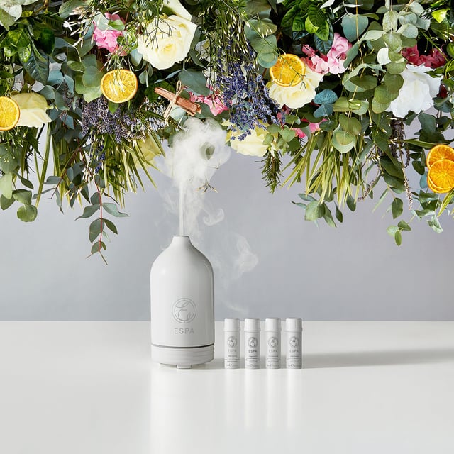 ESPA Aromatherapy Essential Oil Diffuser for Relaxation and Wellness Transform your living space with the ESPA Aromatherapy Essential Oil Diffuser. This stylish diffuser releases a mist of essential oils, enhancing your environment with soothing aromas that promote relaxation and well-being. It works seamlessly with ESPA's Signature Blends, helping you unwind or boost your mood. The ultrasonic technology humidifies the air and disperses fragrant vapor. With customizable light settings, it also serves as a gentle nightlight. To use, fill the water tank, add essential oil, select a misting mode, and enjoy the aromatic experience. (Essential oils sold separately.)