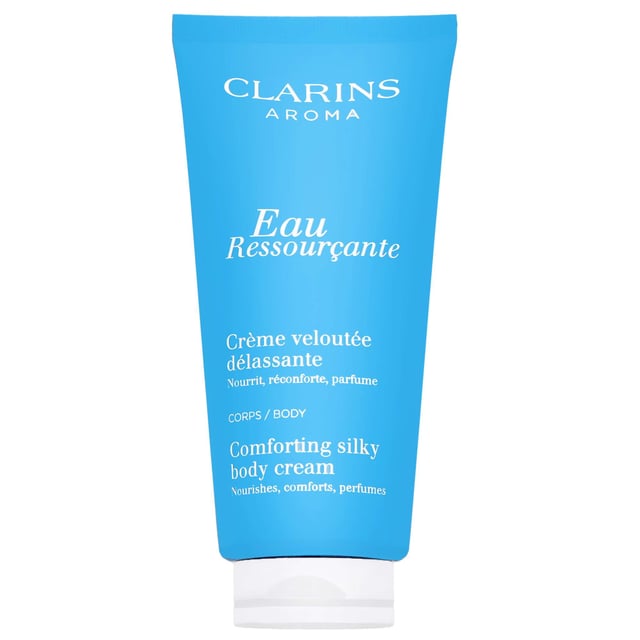 Indulge your skin with the Clarins Eau Ressourcante Comforting Silky Body Cream. This luxurious body cream offers rich nourishment while enveloping you in a soothing woody aroma. Infused with extracts of sarsaparilla, robinia, and longan, it enhances your skin's softness and provides a comforting finish. Perfect for daily use, simply apply to clean skin with gentle, sweeping motions to experience the ultimate pampering. Treat yourself to this delightful skincare essential and enjoy silky smooth skin all day long.