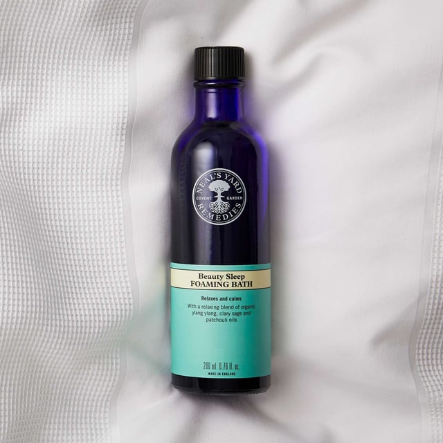 Transform your nighttime routine with Neal's Yard Remedies Beauty Sleep Foaming Bath. This luxurious bath is infused with essential oils like ylang ylang and clary sage, designed to calm your mind and body. Pour under warm running water, swirl to create foam, and immerse yourself in the tranquil aromas that promote relaxation and restful sleep. Made from 98% natural ingredients, this foaming bath ensures a gentle experience for your skin. Embrace Neal's Yard Remedies' commitment to sustainability and indulge in a serene soak for a peaceful night.