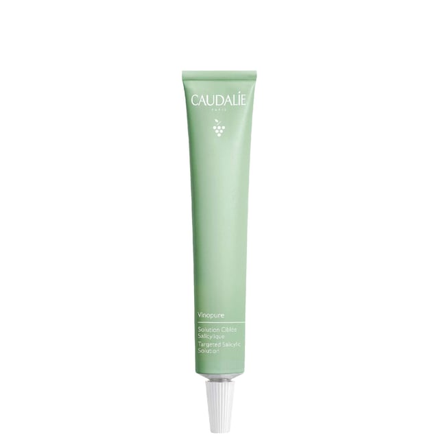 Discover the ultimate solution for blemishes with Caudalie Vinopure Salicylic Acid Spot Treatment. This fast-acting remedy harnesses natural salicylic acid, niacinamide, and tea tree oil to calm irritation and reduce redness. Its unique formula targets spots directly, offering a refreshing botanical scent in an eco-friendly aluminium tube. For best results, apply directly to blemishes and let dry as a mask or leave on overnight for treatment. Join Caudalie's mission to plant trees; they have planted over 8 million trees by 2021.