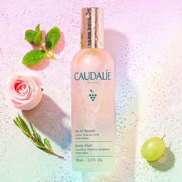 Revitalize your skin with Caudalie's Beauty Elixir, a versatile mist designed to prep and refresh your complexion. This iconic face mist doubles as a makeup setting spray and contains 100% natural ingredients like green grape, orange blossom, and essential oils such as peppermint and rose. Suitable for all skin types, it hydrates, calms, and tightens pores. Use it in your skincare routine or as a quick refresh. Loved by A-listers and makeup artists, this vegan formula is a handbag essential for a radiant glow. Enjoy a cooling sensation by storing it in the fridge.