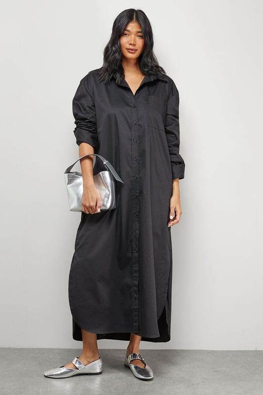 Oversized fit with dramatic side splits for effortless movement
        Midi length design with classic collar and full button-through front
        Long sleeves with buttoned cuffs for versatile styling options
        Relaxed dropped shoulders creating a contemporary silhouette
        Chest pocket detail adding subtle functional interest
    
    Make a statement with this Warehouse oversized midi shirt dress, the epitome of casual sophistication. The generous proportions and side splits create a flowing silhouette that moves beautifully with you, whilst the classic shirt detailing keeps the look grounded in timeless style. Perfect for family gatherings when paired with metallic flats as shown, or dress it down further with white trainers and a crossbody bag for weekend brunches. For cooler days, layer over slim-fit trousers and add a chunky knit cardigan. The cotton-rich fabric offers comfort for all-day wear, making this an ideal choice for those busy days when you need to look put-together with minimal effort. This versatile piece transitions effortlessly from casual daytime events to relaxed evening occasions - simply switch your accessories to refresh your look.