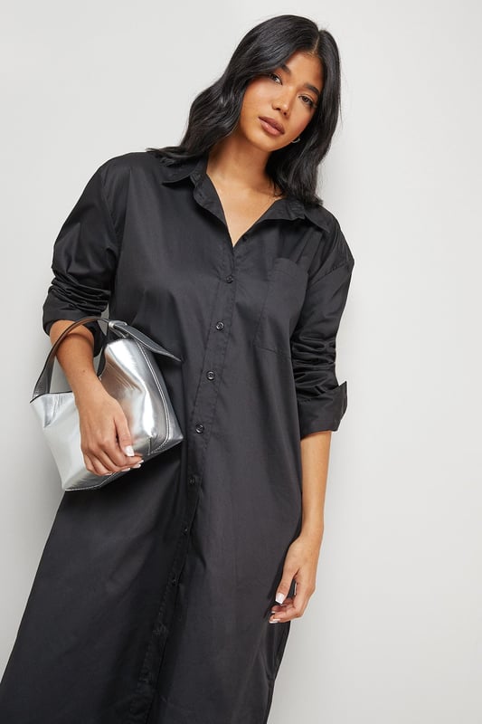 Oversized fit with dramatic side splits for effortless movement
        Midi length design with classic collar and full button-through front
        Long sleeves with buttoned cuffs for versatile styling options
        Relaxed dropped shoulders creating a contemporary silhouette
        Chest pocket detail adding subtle functional interest
    
    Make a statement with this Warehouse oversized midi shirt dress, the epitome of casual sophistication. The generous proportions and side splits create a flowing silhouette that moves beautifully with you, whilst the classic shirt detailing keeps the look grounded in timeless style. Perfect for family gatherings when paired with metallic flats as shown, or dress it down further with white trainers and a crossbody bag for weekend brunches. For cooler days, layer over slim-fit trousers and add a chunky knit cardigan. The cotton-rich fabric offers comfort for all-day wear, making this an ideal choice for those busy days when you need to look put-together with minimal effort. This versatile piece transitions effortlessly from casual daytime events to relaxed evening occasions - simply switch your accessories to refresh your look.