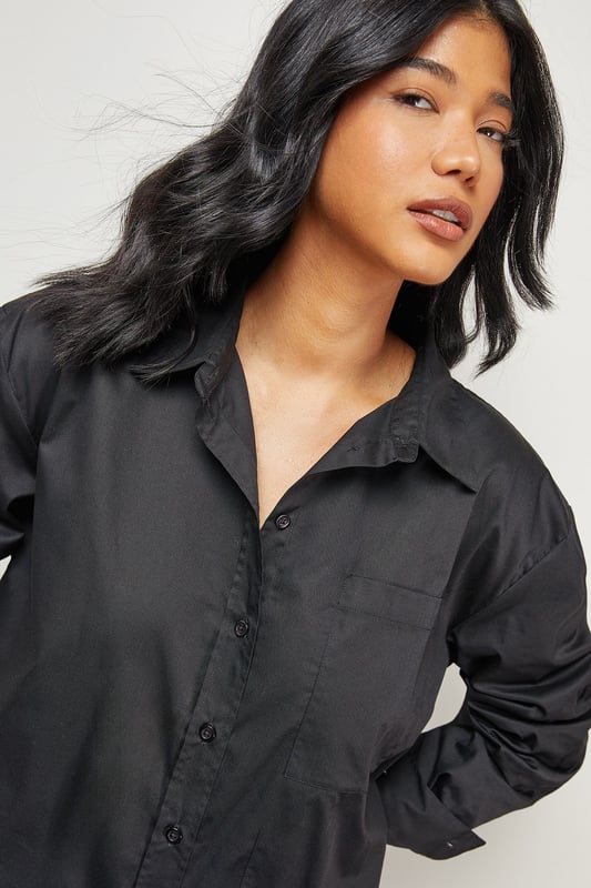 Oversized fit with dramatic side splits for effortless movement
        Midi length design with classic collar and full button-through front
        Long sleeves with buttoned cuffs for versatile styling options
        Relaxed dropped shoulders creating a contemporary silhouette
        Chest pocket detail adding subtle functional interest
    
    Make a statement with this Warehouse oversized midi shirt dress, the epitome of casual sophistication. The generous proportions and side splits create a flowing silhouette that moves beautifully with you, whilst the classic shirt detailing keeps the look grounded in timeless style. Perfect for family gatherings when paired with metallic flats as shown, or dress it down further with white trainers and a crossbody bag for weekend brunches. For cooler days, layer over slim-fit trousers and add a chunky knit cardigan. The cotton-rich fabric offers comfort for all-day wear, making this an ideal choice for those busy days when you need to look put-together with minimal effort. This versatile piece transitions effortlessly from casual daytime events to relaxed evening occasions - simply switch your accessories to refresh your look.