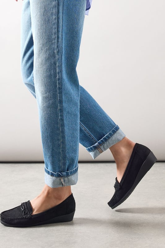 Faux suede moccasin loafers with decorative trim detail for a classic finish
        Subtle wedge heel (under 2cm) provides gentle lift without sacrificing comfort
        Cushioned footbed designed specifically for all-day wear
        Slip-on style with moccasin stitching for effortless everyday dressing
        Part of our Good For The Sole collection, crafted with comfort in mind
    
    These Viridiana moccasin loafers blend timeless style with exceptional comfort, making them a wardrobe essential for the modern woman. The subtle wedge provides just enough height to flatter without compromising on wearability, whilst the faux suede texture adds a touch of sophistication to casual ensembles. Style them with rolled-up jeans for a relaxed weekend look, or pair with tailored trousers and a crisp shirt for smart-casual office days. The versatile design works beautifully with everything from floaty midi dresses to cropped trousers, making these loafers perfect for family gatherings, casual brunches, or those busy days when you're on your feet. The thoughtful comfort features ensure these will quickly become your go-to footwear choice when you need both style and practicality.