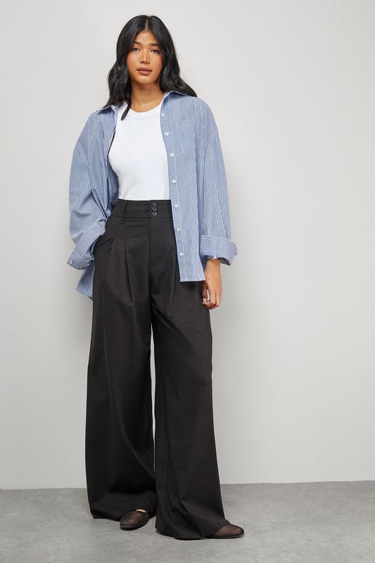 Tailored wide-leg silhouette with dramatic floor-sweeping length
        Front pleats for added structure and dimension
        Practical side pockets for everyday functionality
        Secure button and clasp waistband closure
        Linen blend fabric offering breathable comfort with a refined drape
    
    Make a confident statement with these Warehouse tailored trousers that combine contemporary styling with everyday wearability. The wide-leg design creates a flowing silhouette that moves beautifully with every step, while the structured pleats add a touch of sophistication. These versatile trousers transition effortlessly from day to evening - pair with a crisp white t-shirt and oversized shirt for a relaxed daytime look, or style with a fitted bodysuit and statement jewellery for dinner with friends. The linen blend fabric ensures these trousers maintain their shape whilst offering breathability for all-day comfort. Complete the ensemble with chunky loafers or trainers for an edgy, modern finish that captures Warehouse's confident aesthetic. Perfect for family gatherings, weekend brunches or casual workplace settings where comfort meets style.