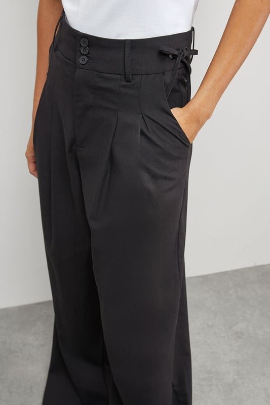Tailored wide-leg silhouette with dramatic floor-sweeping length
        Front pleats for added structure and dimension
        Practical side pockets for everyday functionality
        Secure button and clasp waistband closure
        Linen blend fabric offering breathable comfort with a refined drape
    
    Make a confident statement with these Warehouse tailored trousers that combine contemporary styling with everyday wearability. The wide-leg design creates a flowing silhouette that moves beautifully with every step, while the structured pleats add a touch of sophistication. These versatile trousers transition effortlessly from day to evening - pair with a crisp white t-shirt and oversized shirt for a relaxed daytime look, or style with a fitted bodysuit and statement jewellery for dinner with friends. The linen blend fabric ensures these trousers maintain their shape whilst offering breathability for all-day comfort. Complete the ensemble with chunky loafers or trainers for an edgy, modern finish that captures Warehouse's confident aesthetic. Perfect for family gatherings, weekend brunches or casual workplace settings where comfort meets style.