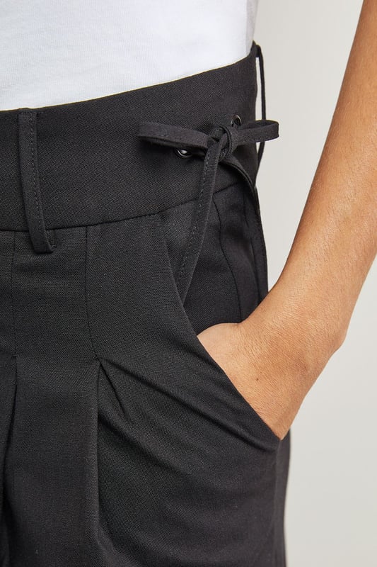 Tailored wide-leg silhouette with dramatic floor-sweeping length
        Front pleats for added structure and dimension
        Practical side pockets for everyday functionality
        Secure button and clasp waistband closure
        Linen blend fabric offering breathable comfort with a refined drape
    
    Make a confident statement with these Warehouse tailored trousers that combine contemporary styling with everyday wearability. The wide-leg design creates a flowing silhouette that moves beautifully with every step, while the structured pleats add a touch of sophistication. These versatile trousers transition effortlessly from day to evening - pair with a crisp white t-shirt and oversized shirt for a relaxed daytime look, or style with a fitted bodysuit and statement jewellery for dinner with friends. The linen blend fabric ensures these trousers maintain their shape whilst offering breathability for all-day comfort. Complete the ensemble with chunky loafers or trainers for an edgy, modern finish that captures Warehouse's confident aesthetic. Perfect for family gatherings, weekend brunches or casual workplace settings where comfort meets style.