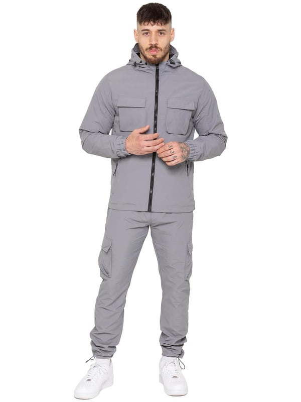 Gear up with the Enzo Milano Men’s Lightweight Cargo Jacket & Pants Set, built for comfort, function, and style. The jacket features water-repellent crushed poly fabric with a breathable mesh lining, full zip front, adjustable hood, and multiple secure pockets. Paired with lightweight cargo pants in a regular fit, this set includes an elasticated waistband with drawstring, cargo pockets, and adjustable hems for a personalized fit.