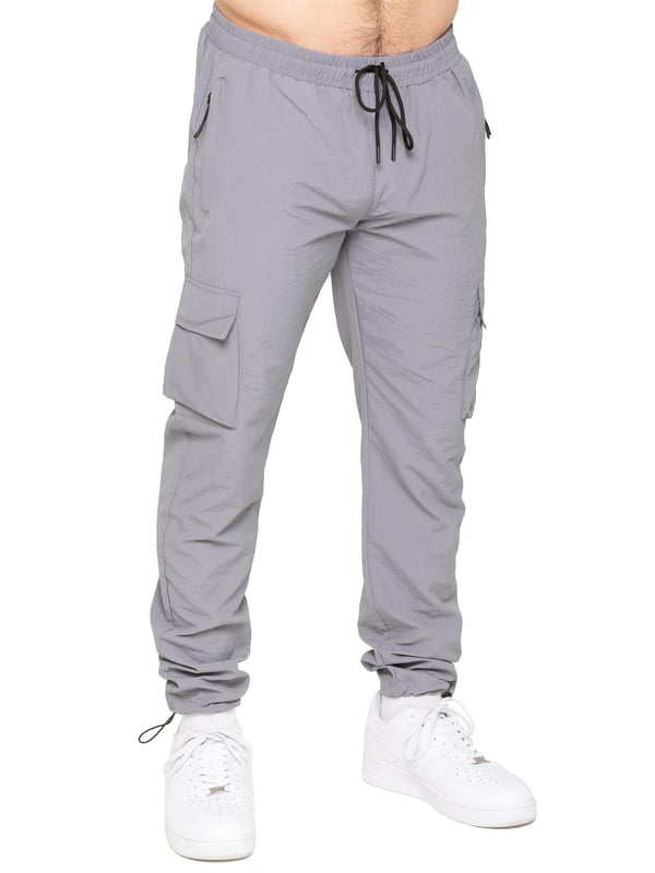 Gear up with the Enzo Milano Men’s Lightweight Cargo Jacket & Pants Set, built for comfort, function, and style. The jacket features water-repellent crushed poly fabric with a breathable mesh lining, full zip front, adjustable hood, and multiple secure pockets. Paired with lightweight cargo pants in a regular fit, this set includes an elasticated waistband with drawstring, cargo pockets, and adjustable hems for a personalized fit.