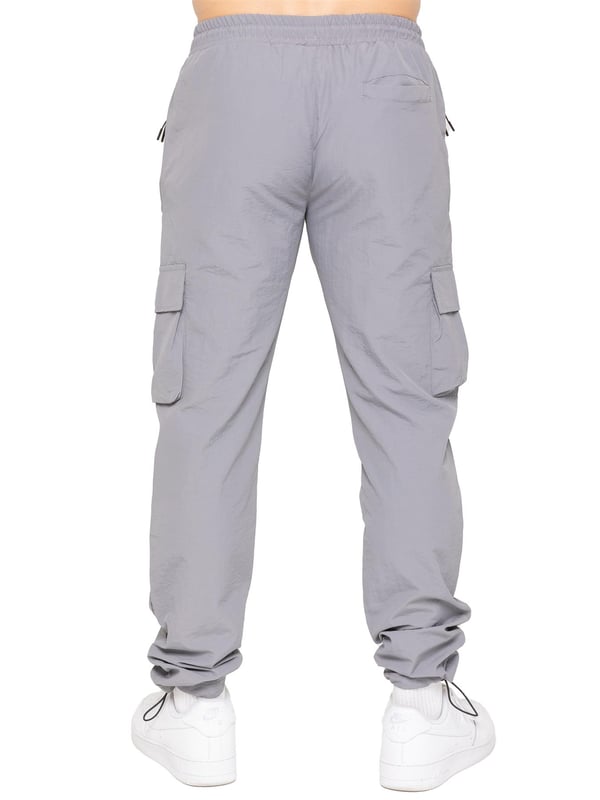 Gear up with the Enzo Milano Men’s Lightweight Cargo Jacket & Pants Set, built for comfort, function, and style. The jacket features water-repellent crushed poly fabric with a breathable mesh lining, full zip front, adjustable hood, and multiple secure pockets. Paired with lightweight cargo pants in a regular fit, this set includes an elasticated waistband with drawstring, cargo pockets, and adjustable hems for a personalized fit.