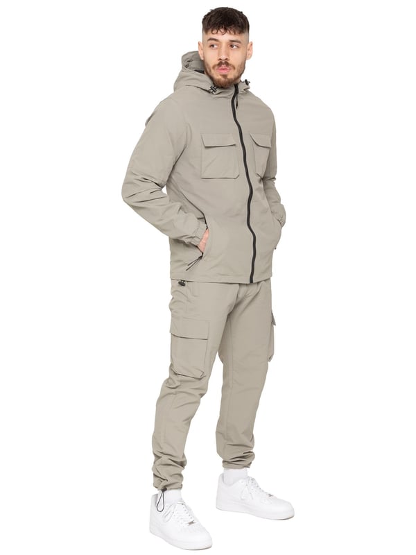 Gear up with the Enzo Milano Men’s Lightweight Cargo Jacket & Pants Set, built for comfort, function, and style. The jacket features water-repellent crushed poly fabric with a breathable mesh lining, full zip front, adjustable hood, and multiple secure pockets. Paired with lightweight cargo pants in a regular fit, this set includes an elasticated waistband with drawstring, cargo pockets, and adjustable hems for a personalized fit.
