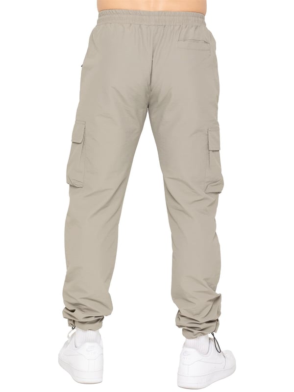 Gear up with the Enzo Milano Men’s Lightweight Cargo Jacket & Pants Set, built for comfort, function, and style. The jacket features water-repellent crushed poly fabric with a breathable mesh lining, full zip front, adjustable hood, and multiple secure pockets. Paired with lightweight cargo pants in a regular fit, this set includes an elasticated waistband with drawstring, cargo pockets, and adjustable hems for a personalized fit.