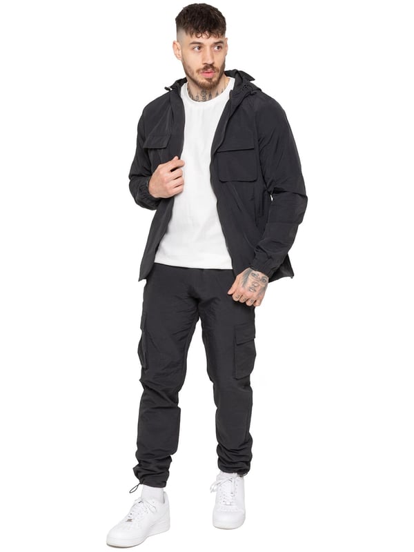 Gear up with the Enzo Milano Men’s Lightweight Cargo Jacket & Pants Set, built for comfort, function, and style. The jacket features water-repellent crushed poly fabric with a breathable mesh lining, full zip front, adjustable hood, and multiple secure pockets. Paired with lightweight cargo pants in a regular fit, this set includes an elasticated waistband with drawstring, cargo pockets, and adjustable hems for a personalized fit.