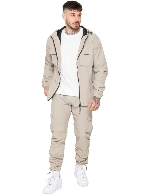 Gear up with the Enzo Milano Men’s Lightweight Cargo Jacket & Pants Set, built for comfort, function, and style. The jacket features water-repellent crushed poly fabric with a breathable mesh lining, full zip front, adjustable hood, and multiple secure pockets. Paired with lightweight cargo pants in a regular fit, this set includes an elasticated waistband with drawstring, cargo pockets, and adjustable hems for a personalized fit.