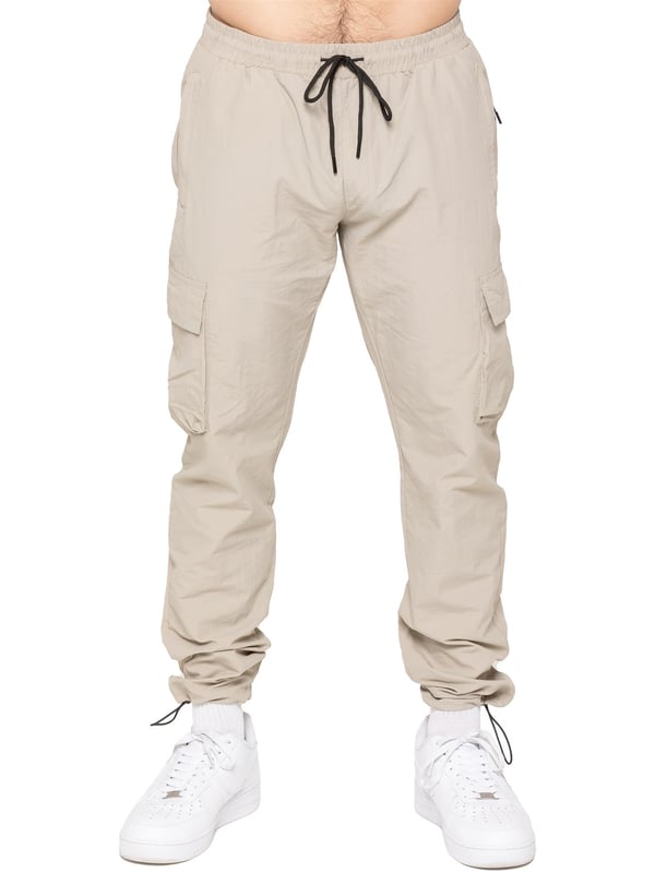 Gear up with the Enzo Milano Men’s Lightweight Cargo Jacket & Pants Set, built for comfort, function, and style. The jacket features water-repellent crushed poly fabric with a breathable mesh lining, full zip front, adjustable hood, and multiple secure pockets. Paired with lightweight cargo pants in a regular fit, this set includes an elasticated waistband with drawstring, cargo pockets, and adjustable hems for a personalized fit.