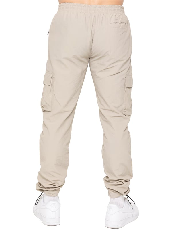 Gear up with the Enzo Milano Men’s Lightweight Cargo Jacket & Pants Set, built for comfort, function, and style. The jacket features water-repellent crushed poly fabric with a breathable mesh lining, full zip front, adjustable hood, and multiple secure pockets. Paired with lightweight cargo pants in a regular fit, this set includes an elasticated waistband with drawstring, cargo pockets, and adjustable hems for a personalized fit.