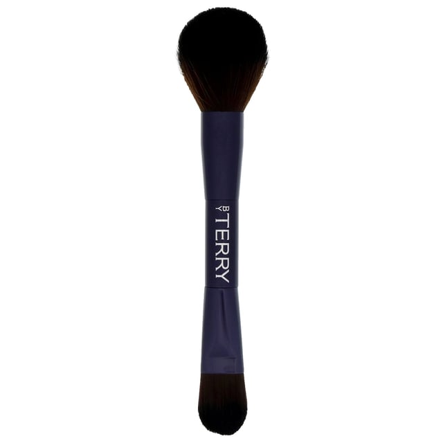 Discover the By Terry Tool-Expert Dual-Ended Makeup Brush, designed by renowned makeup artist Terry de Gunzburg. With over 30 years of experience, Terry has revolutionized the beauty industry since founding By Terry in 1998. This luxurious brush features a flat side for applying liquid and cream foundations effortlessly, while the domed side is perfect for pressed and loose powders. Achieve a professional-quality finish with every use, as this brush ensures even product distribution for a smooth look. Elevate your makeup routine with this essential tool that combines convenience and efficacy.