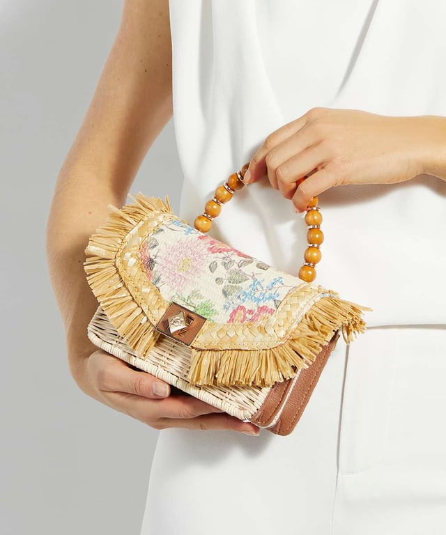 Update your summer style with Blooms. Available in boucle and denim this foldover profile features sparkling jewel embellished flowers and our signature turn lock closure. This woven style features a removable cross body strap, and a striking beaded top handle offers the final touch of distinction.