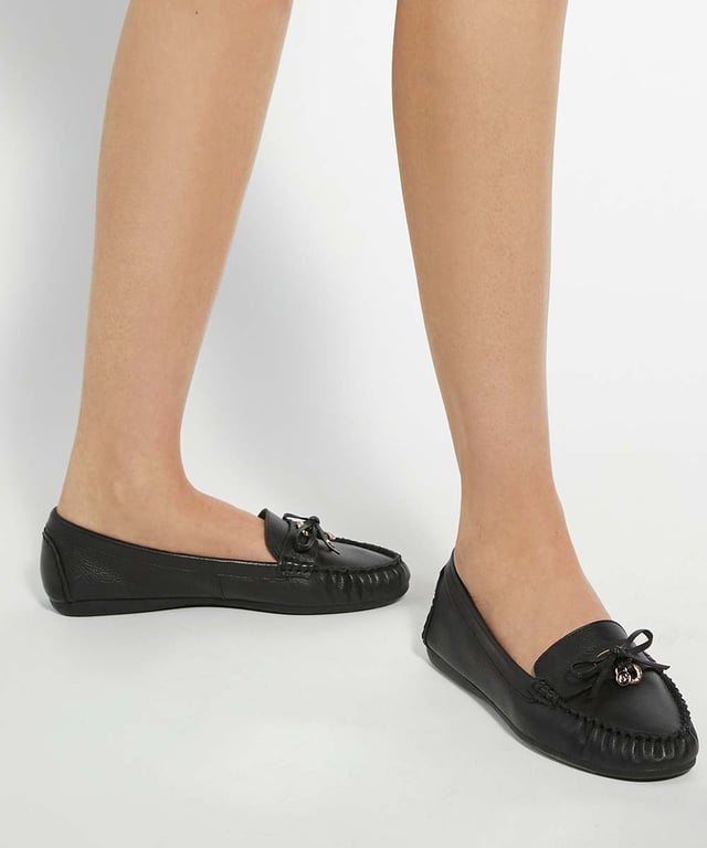 Comfortable and stylish, our Grovers leather moccasins feature an ornate bow trimmed with a gold logo and round jewelled charm. With a cushioned insole, slip them on for a casual day out or dress them up for smarter moments.