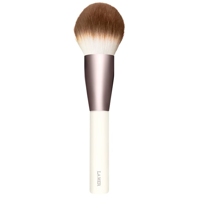 Discover the ultimate makeup application with the LA MER Powder Brush. Designed with a dense head and thousands of ultra-soft bristles, this brush delivers customizable coverage, allowing you to achieve anything from sheer to full coverage with your favorite powder makeup. Crafted with high-quality synthetic bristles, it ensures a hygienic and easy-to-maintain tool for your beauty routine. Elevate your makeup game with this essential accessory that combines luxury and functionality.