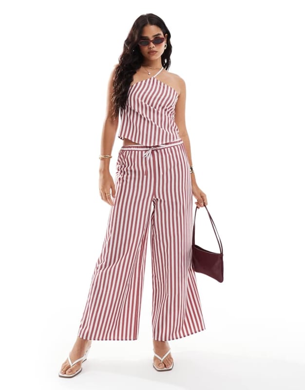 Tops by ASOS DESIGN Part of a co-ord set Shorts sold separately Halterneck style Tie strap Button placket to side Regular fitSold By: Asos