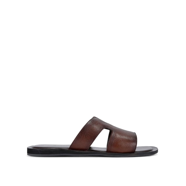 This KG Kurt Geiger Venice is a slip-on sandals crafted from a brown textured leather. The footbed is lightly padded.