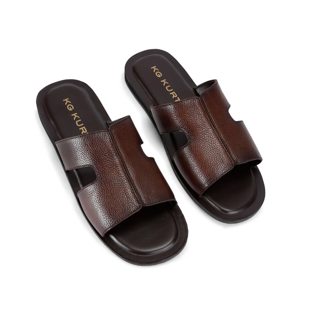This KG Kurt Geiger Venice is a slip-on sandals crafted from a brown textured leather. The footbed is lightly padded.