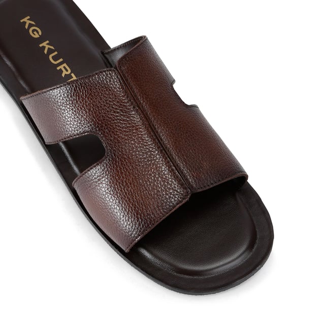 This KG Kurt Geiger Venice is a slip-on sandals crafted from a brown textured leather. The footbed is lightly padded.
