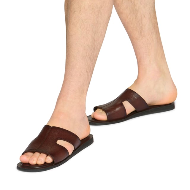 This KG Kurt Geiger Venice is a slip-on sandals crafted from a brown textured leather. The footbed is lightly padded.