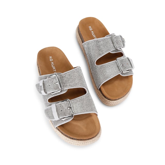 This KG Kurt Geiger Raquel Gem is a slip-on sandal with silver crystal embellishment across both of the straps. The straps are fastened with silver buckles and the sole is in a rope style.