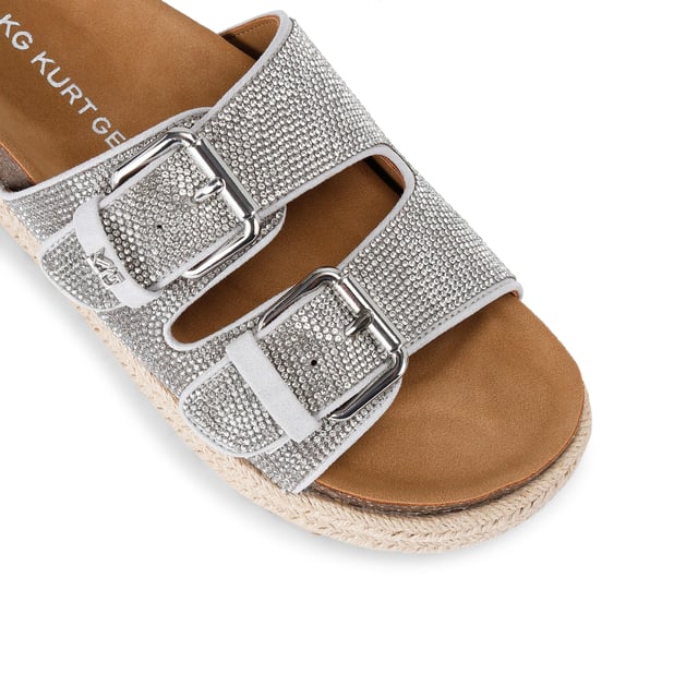 This KG Kurt Geiger Raquel Gem is a slip-on sandal with silver crystal embellishment across both of the straps. The straps are fastened with silver buckles and the sole is in a rope style.