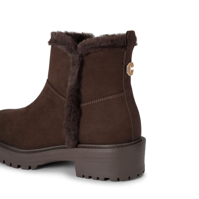 This Carvela Cosy Ankle boot features a brown microsuede upper with faux fur lining on the interior. There is a gold Icon C at the back of the ankle.