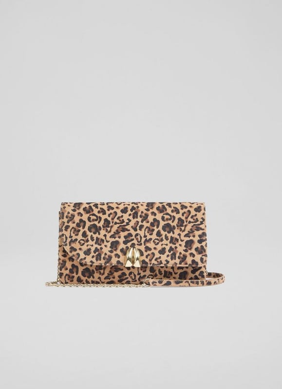 The Aria curve flap clutch bag is crafted from luxurious printed suede in a deep brown shade and lined with soft cotton. This Spanish-made accessory showcases exquisite craftsmanship. Perfect for pairing with your favorite tailored outfit or a flowing dress, it promises a refined look thatâ€™s sure to turn heads.