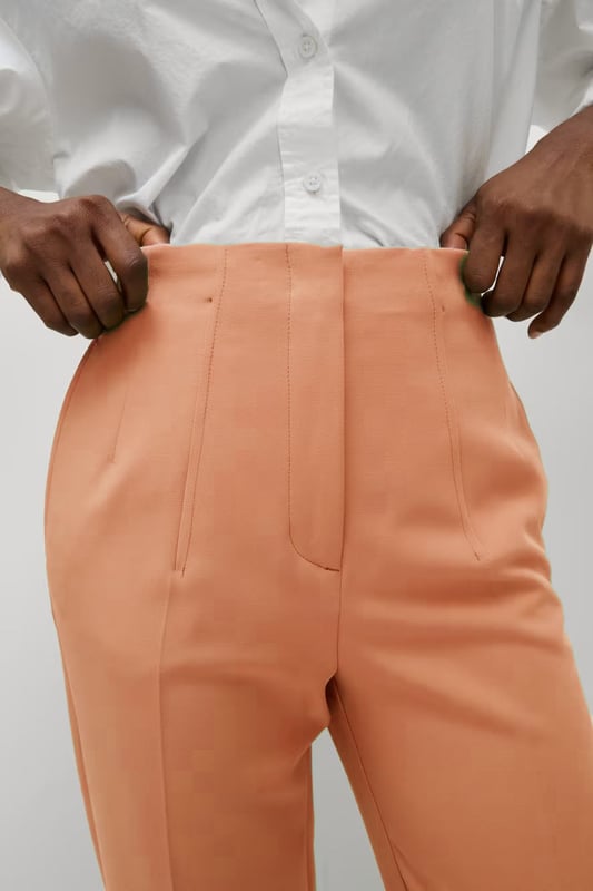 These trousers offer easy wear for smart and casual occasions alike. They have tapered legs with added stretch for comfort and an ankle-grazer length for a contemporary look. The elasticated high waist features double darts for a tailored effect and fastens securely with a hook bar and zip with a concealed button.