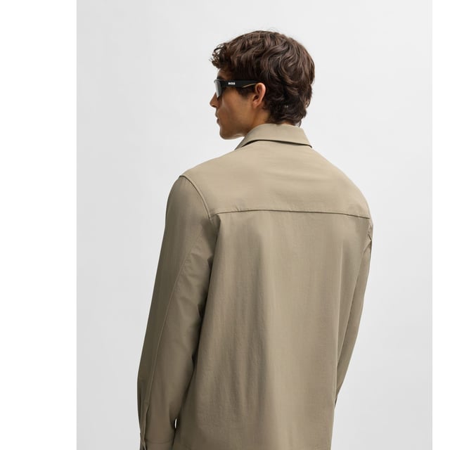 Mens BOSS Basin Relaxed-Fit Overshirt in Water-Repellent Stretch Fabric in beigeWith elbow darts for an ergonomic fit  this BOSS Menswear overshirt is cut in super-stretch fabric. Quick-dry performance with an easy-iron finish.- Relaxed fit- Kent collar- Squared cuffs- Standard length- 90% Polyamide  10% Elastane.  Machine washable.- Ref: 50533265-334