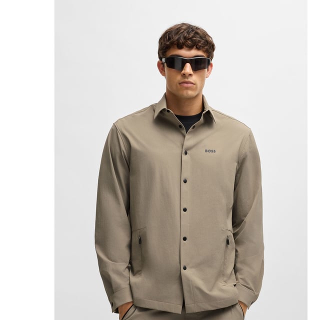 Mens BOSS Basin Relaxed-Fit Overshirt in Water-Repellent Stretch Fabric in beigeWith elbow darts for an ergonomic fit  this BOSS Menswear overshirt is cut in super-stretch fabric. Quick-dry performance with an easy-iron finish.- Relaxed fit- Kent collar- Squared cuffs- Standard length- 90% Polyamide  10% Elastane.  Machine washable.- Ref: 50533265-334