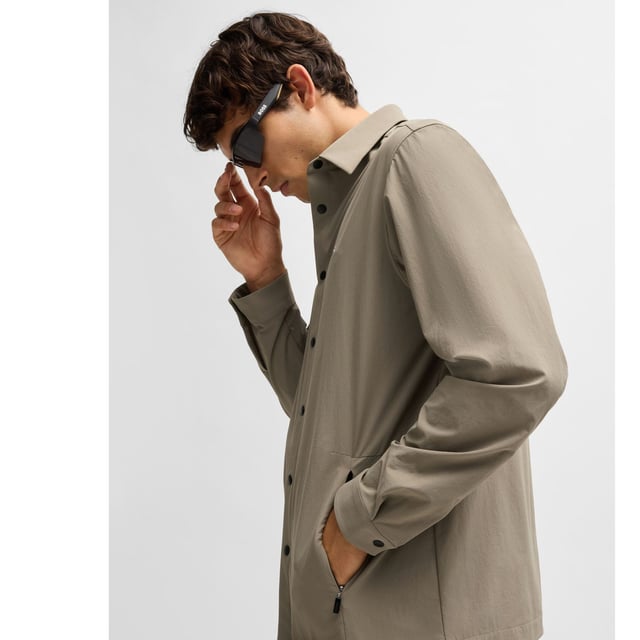 Mens BOSS Basin Relaxed-Fit Overshirt in Water-Repellent Stretch Fabric in beigeWith elbow darts for an ergonomic fit  this BOSS Menswear overshirt is cut in super-stretch fabric. Quick-dry performance with an easy-iron finish.- Relaxed fit- Kent collar- Squared cuffs- Standard length- 90% Polyamide  10% Elastane.  Machine washable.- Ref: 50533265-334