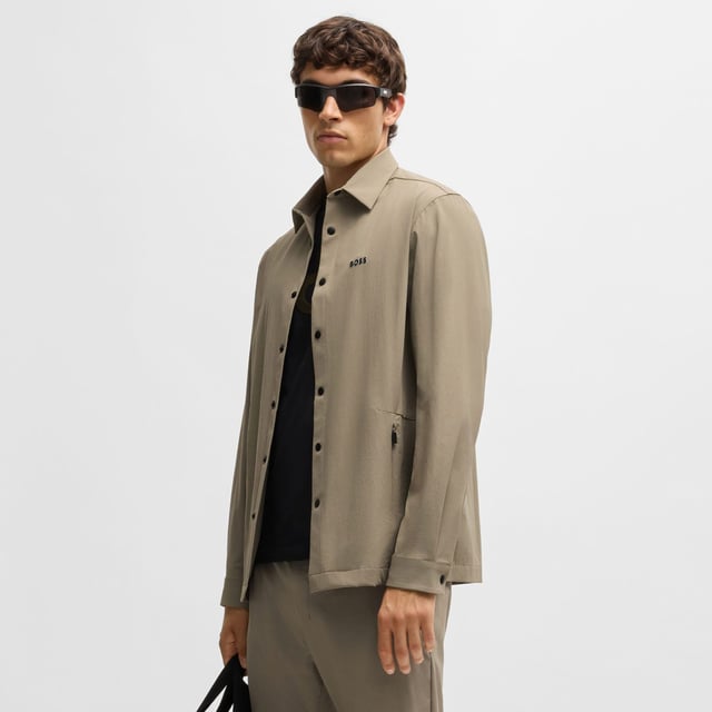 Mens BOSS Basin Relaxed-Fit Overshirt in Water-Repellent Stretch Fabric in beigeWith elbow darts for an ergonomic fit  this BOSS Menswear overshirt is cut in super-stretch fabric. Quick-dry performance with an easy-iron finish.- Relaxed fit- Kent collar- Squared cuffs- Standard length- 90% Polyamide  10% Elastane.  Machine washable.- Ref: 50533265-334