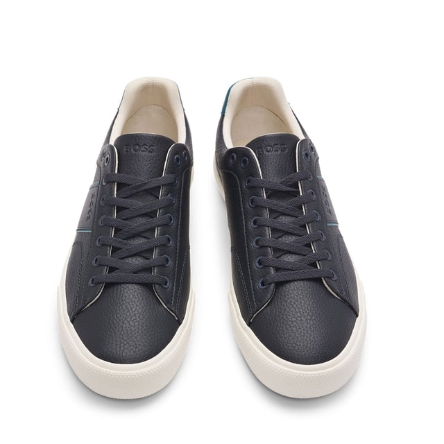 Men's Boss Aiden Tennis Trainers in Blue Mens BOSS Aiden Faux-Leather Trainers with plain and grained textures in open blue.Sporty trainers with piping and debossed branding by BOSS. This pair is crafted in synthetic coated fabric with grained and plain finishes. Synthetic coated fabric sometimes referred to as faux leather is a fabric designed to resemble real leather and-or display a matte glossy smooth or textured coated appearance. - Laces- Fully lined- Packaging: Box- Upper material: 60% Polyurethane 40% Polyester. Lining: 100% Polyester 85% Polyester 15% Polyurethane. Sole: 100% Rubber. Innersole: 100% Polyester.- Ref: 50522833-464