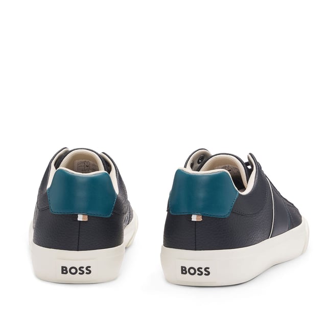 Men's Boss Aiden Tennis Trainers in Blue Mens BOSS Aiden Faux-Leather Trainers with plain and grained textures in open blue.Sporty trainers with piping and debossed branding by BOSS. This pair is crafted in synthetic coated fabric with grained and plain finishes. Synthetic coated fabric sometimes referred to as faux leather is a fabric designed to resemble real leather and-or display a matte glossy smooth or textured coated appearance. - Laces- Fully lined- Packaging: Box- Upper material: 60% Polyurethane 40% Polyester. Lining: 100% Polyester 85% Polyester 15% Polyurethane. Sole: 100% Rubber. Innersole: 100% Polyester.- Ref: 50522833-464