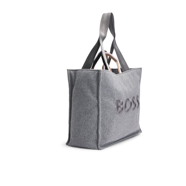 Womens BOSS Deva Tote Bag with Oversized Embroidered Logo in medium grey An open-top tote bag with signature-stripe handles by BOSS. This modern accessory is crafted in wool-effect fabric with large logo embroidery. - Approx. measurements: 41.5cm (L) x 35cm (H) x 18cm (W)- Open top- 1 inside open pocket- Hardware finishing: Polished silver hardware- Logo embroidery- Double handle- Main material: 100% Polyester (recycled)  Lining: 100% Polyester  Facing: 100% Polyester  100% Polyamide.- Ref: 50529028-030