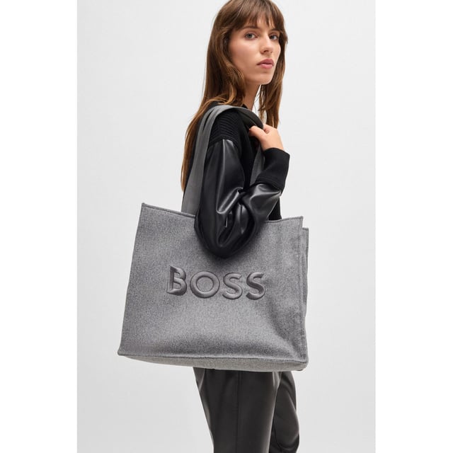 Womens BOSS Deva Tote Bag with Oversized Embroidered Logo in medium grey An open-top tote bag with signature-stripe handles by BOSS. This modern accessory is crafted in wool-effect fabric with large logo embroidery. - Approx. measurements: 41.5cm (L) x 35cm (H) x 18cm (W)- Open top- 1 inside open pocket- Hardware finishing: Polished silver hardware- Logo embroidery- Double handle- Main material: 100% Polyester (recycled)  Lining: 100% Polyester  Facing: 100% Polyester  100% Polyamide.- Ref: 50529028-030