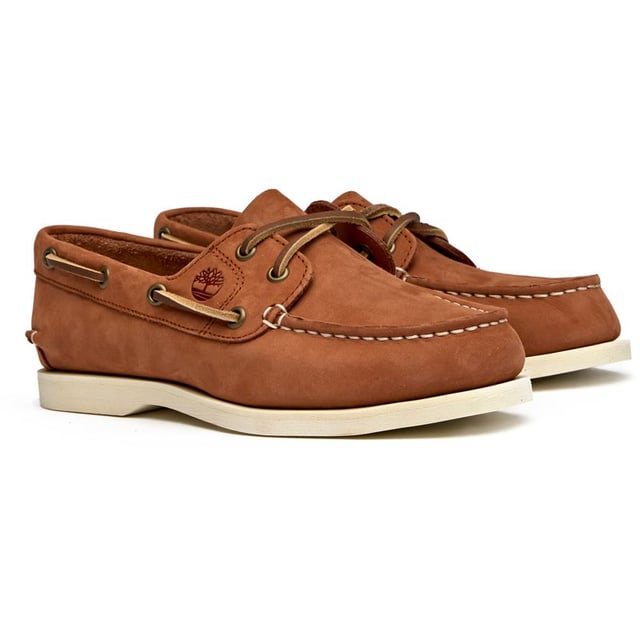 Classic maritime style meets everyday comfort in these women's boat shoes from Timberland. The soft tan nubuck upper offers a premium feel while the flexible rubber sole provides reliable grip whether you're dockside or downtown. A cushioned insock ensures all-day wearability, making these versatile enough to pair with everything from crisp white jeans to flowing summer dresses.