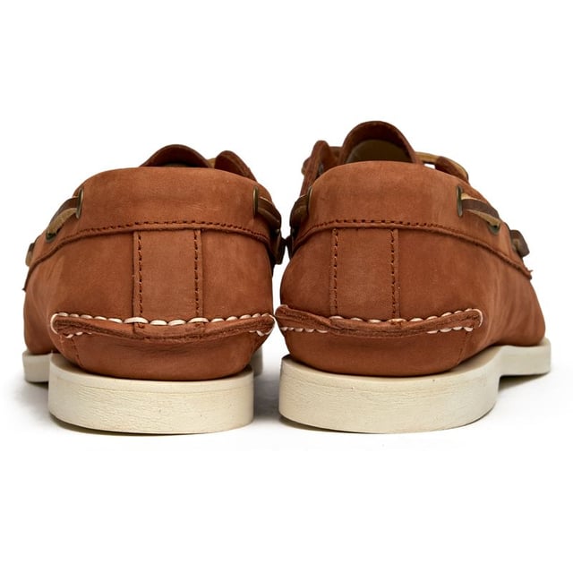 Classic maritime style meets everyday comfort in these women's boat shoes from Timberland. The soft tan nubuck upper offers a premium feel while the flexible rubber sole provides reliable grip whether you're dockside or downtown. A cushioned insock ensures all-day wearability, making these versatile enough to pair with everything from crisp white jeans to flowing summer dresses.