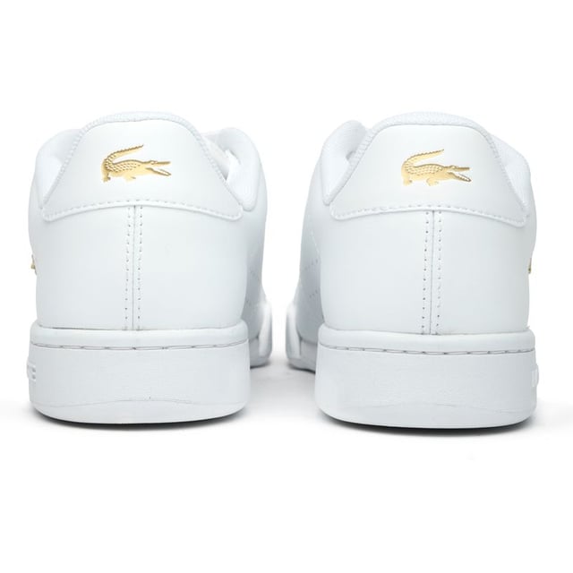Lacoste Carnaby Cup Trainers The Lacoste Carnaby Cup delivers timeless court style with a modern twist. Crafted from quality leather, these women's white trainers showcase elegant metallic accents that catch the light with each step. The robust rubber cup sole provides excellent stability, while signature Lacoste branding adorns the tongue, heel, and quarter - subtle reminders of the heritage behind these sophisticated sneakers. Perfect for casual outings or dressing up your weekend attire.