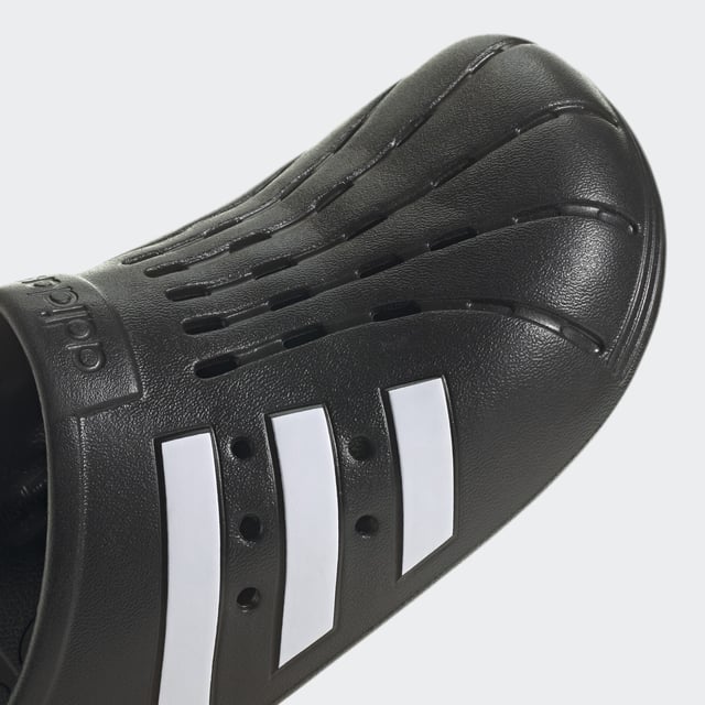 Adilette Clogs Based on the iconic adidas slide, these clogs are as functional as they are comfortable. Whether you're walking to the gym or pool for an early-morning workout or just want to keep the slouchy-casual vibe going all through your day, slip your feet into the contoured footbeds and head for the door. - Regular fit - Slip-on construction - Synthetic upper - Soft feel - Sport-inspired clogs for every day - Contoured EVA footbed - Synthetic outsole Shipped by adidas
