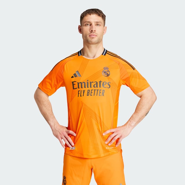 Highlighting the rise of a brand-new football generation. Created to complement Real Madrid's shimmering skills, this adidas away authentic jersey stands out with a vibrant orange base and an abstract, star-inspired design. Its metallic blue details include a heat-applied club badge. Behind the scenes, performance-boosting HEAT.RDY makes for effervescent play.This product is made with 100% recycled materials. By reusing materials that have already been created, adidas help to reduce waste and our reliance on finite resources and reduce the footprint of the products adidas make.  - Slim fit - Ribbed crewneck - 100% polyester (recycled) - HEAT.RDY - Side mesh inserts - Real Madrid heat-applied crest  Shipped by adidas