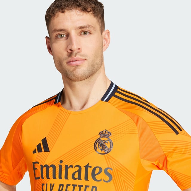Highlighting the rise of a brand-new football generation. Created to complement Real Madrid's shimmering skills, this adidas away authentic jersey stands out with a vibrant orange base and an abstract, star-inspired design. Its metallic blue details include a heat-applied club badge. Behind the scenes, performance-boosting HEAT.RDY makes for effervescent play.This product is made with 100% recycled materials. By reusing materials that have already been created, adidas help to reduce waste and our reliance on finite resources and reduce the footprint of the products adidas make.  - Slim fit - Ribbed crewneck - 100% polyester (recycled) - HEAT.RDY - Side mesh inserts - Real Madrid heat-applied crest  Shipped by adidas